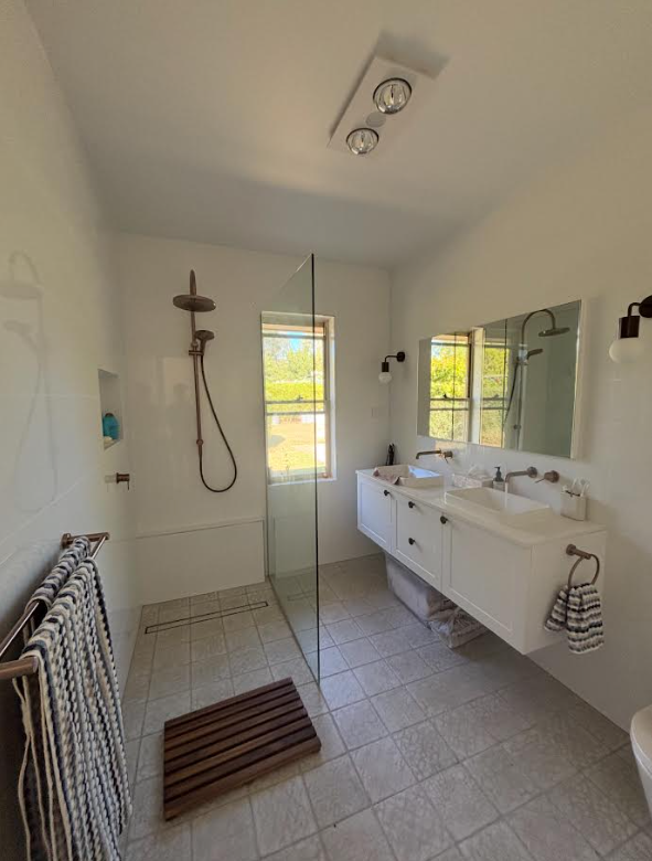 Completed bathroom with walk-in shower and double vanity
